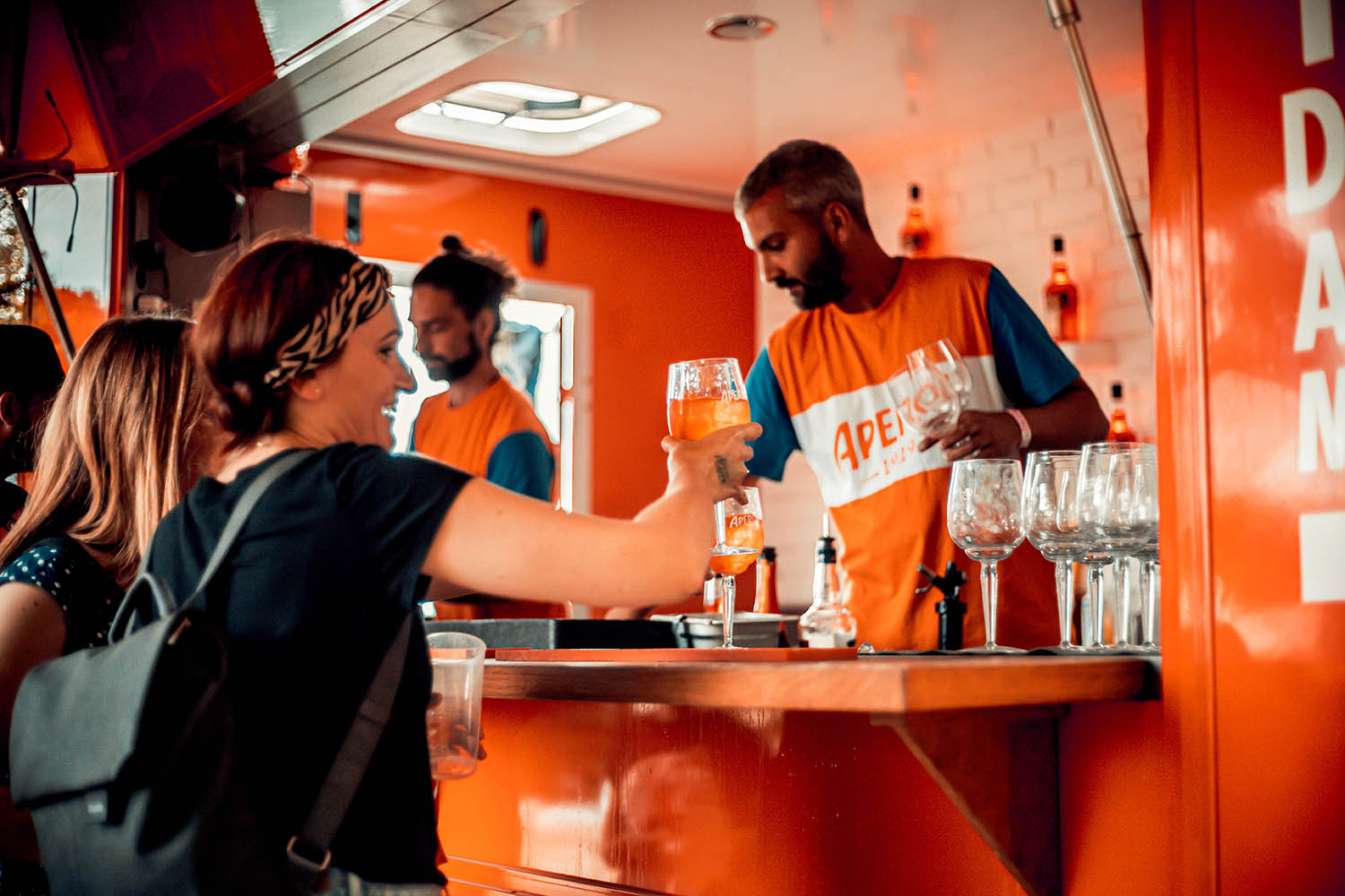 Am Aperol Stand schänkt ein Mitarbeiter ein Kaltgetränk aus